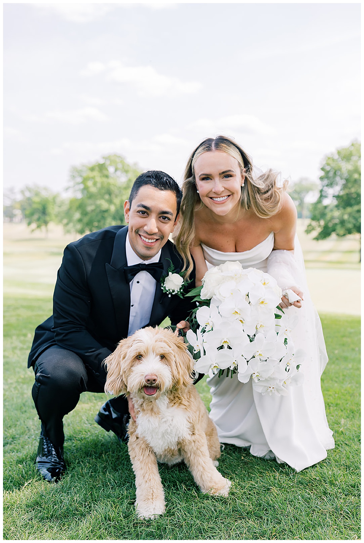 Bride and grooms sit with their dig for Meadowbrook Country Club