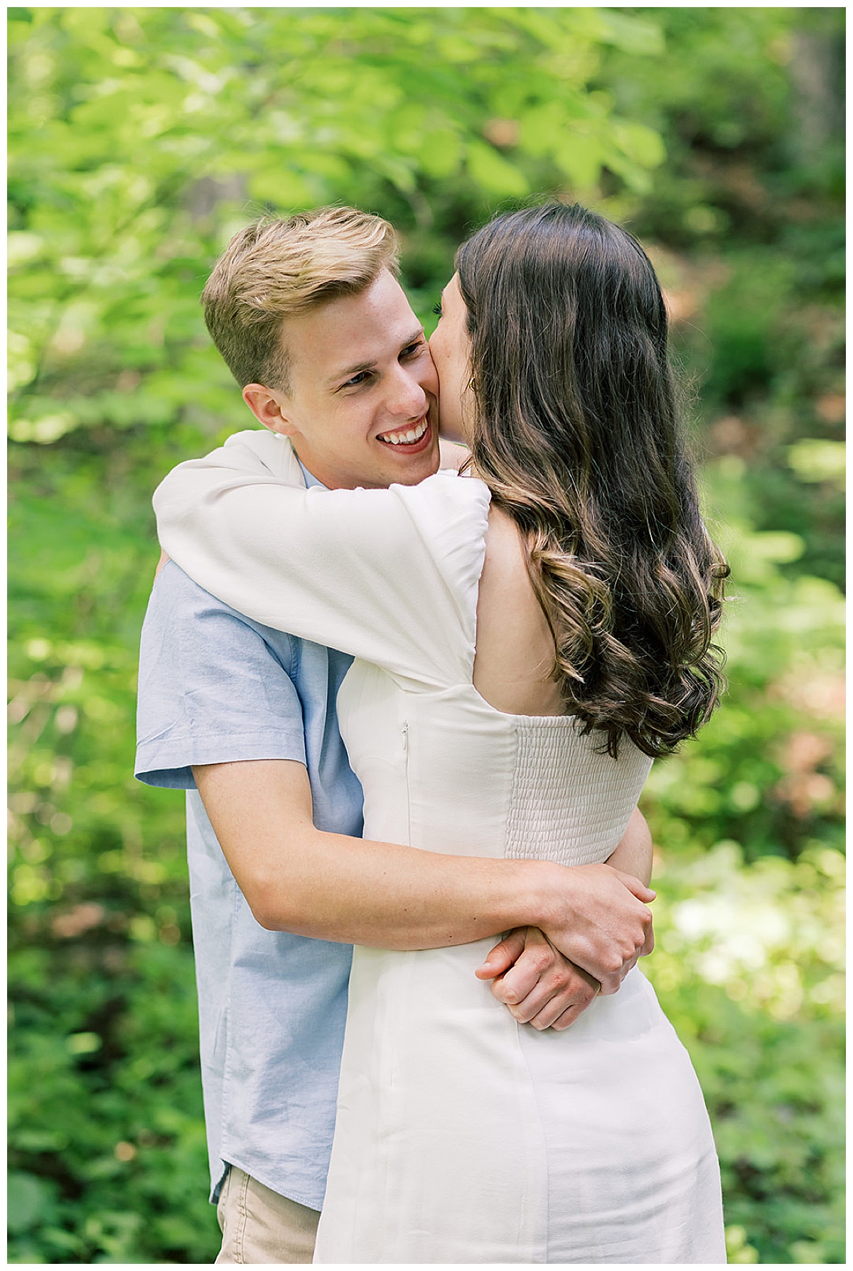 Woman and man hug one another during their Ann Arbor peony garden engagement session