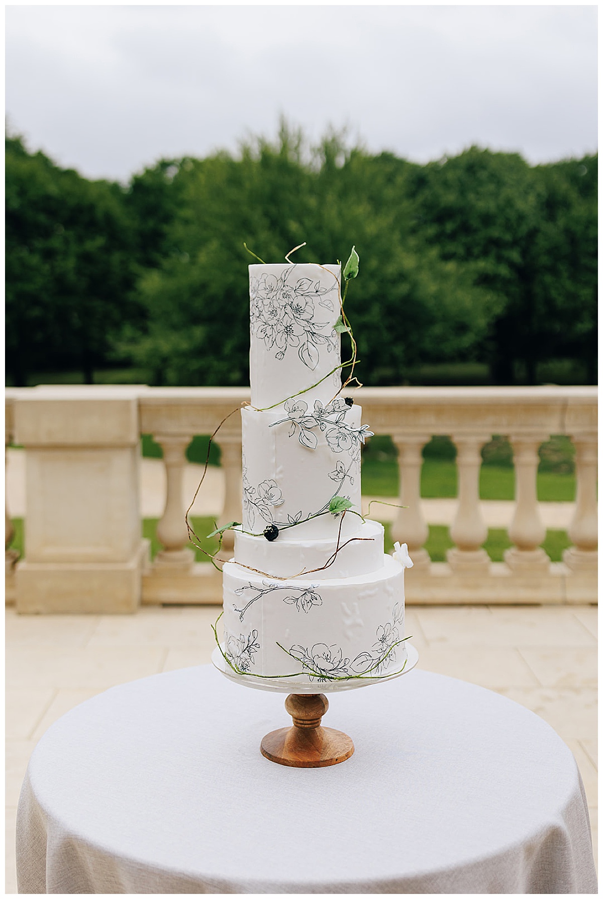 Wedding cake covered in greenery for perfectly executed Wedding Photography Timeline