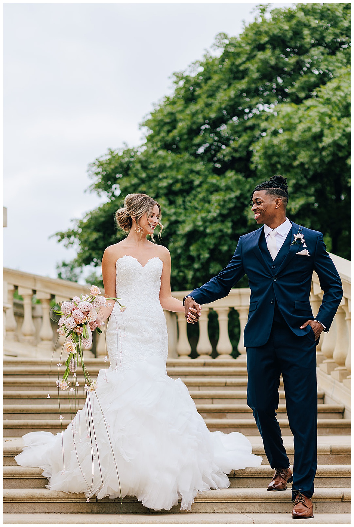 Couple walk down the stairs together for Kayla Bouren Photography