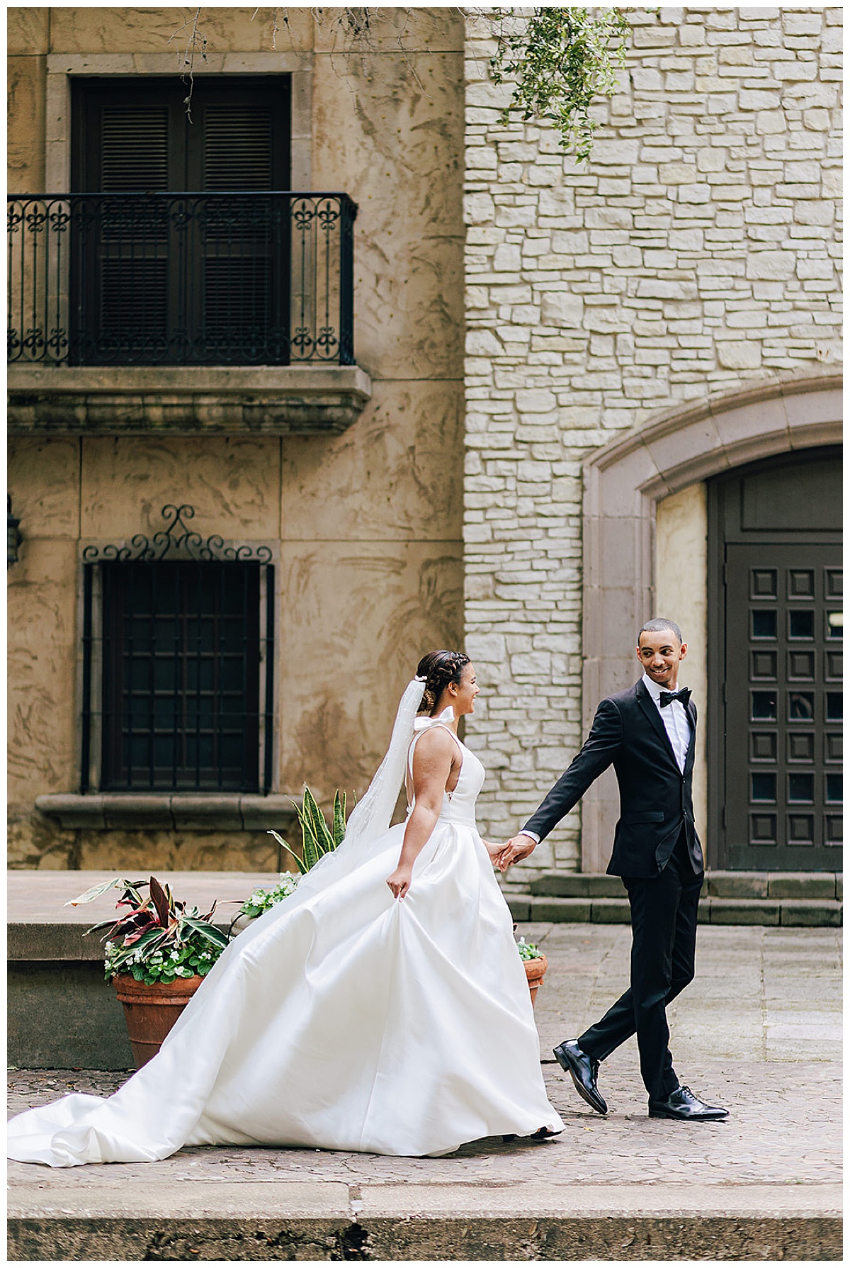Man leads woman down the walkway for Detroit Wedding Photographer
