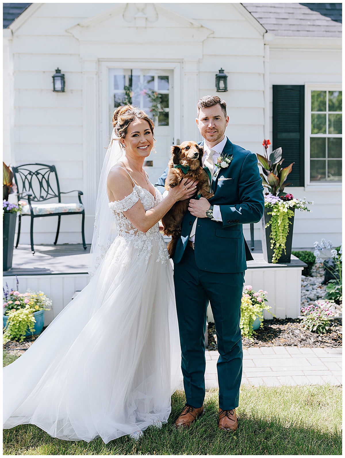 Bride and groom hold their dog at their Holly, Michigan Wedding Venue 