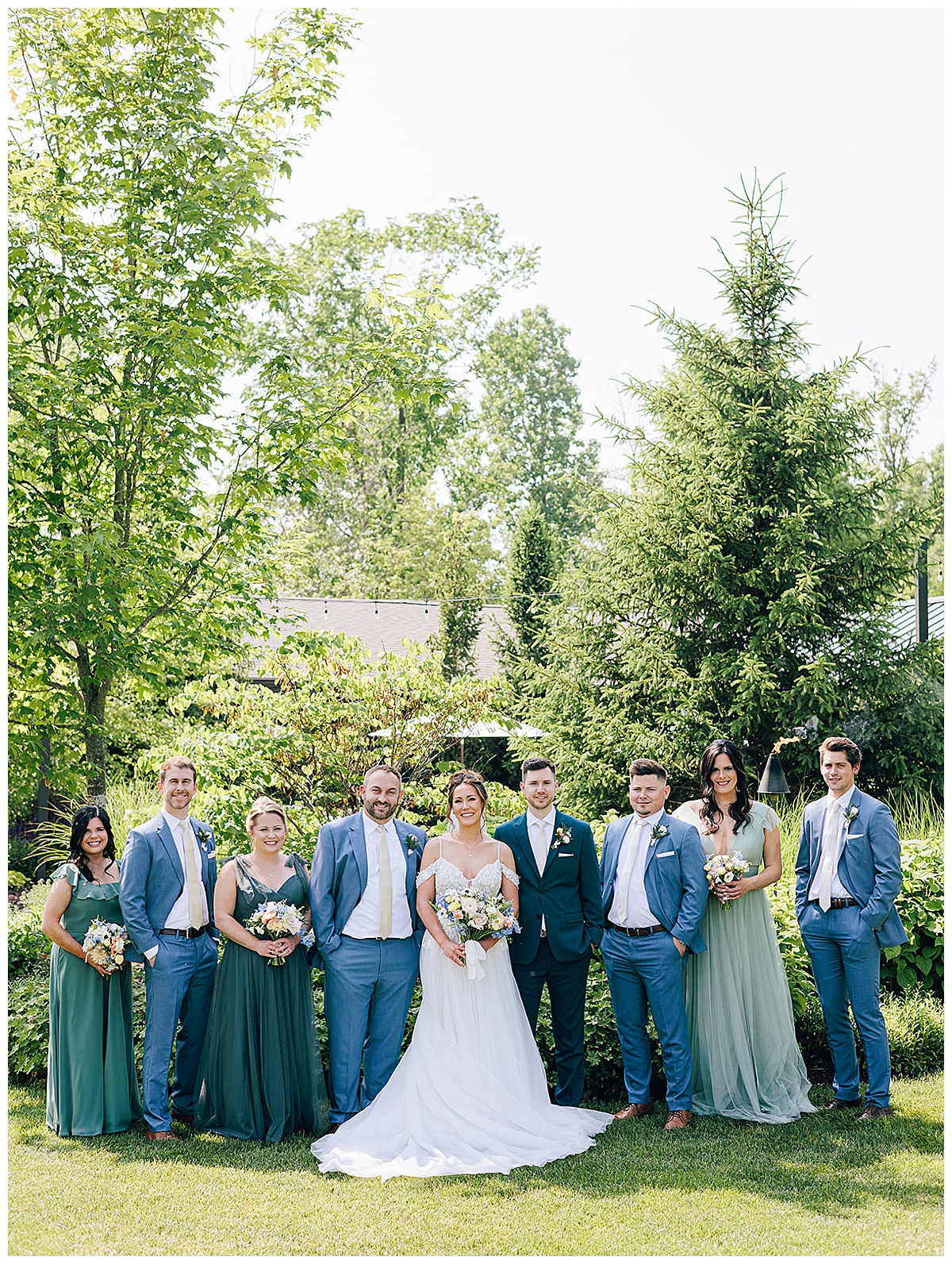 Wedding party surround happy couple for Kayla Bouren Photography