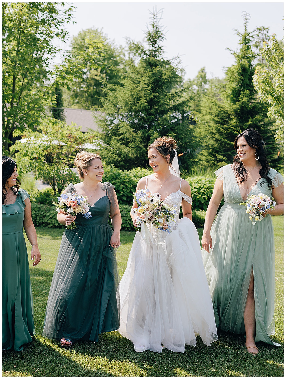 Bride walks with friends and family at their Holly, Michigan Wedding Venue 