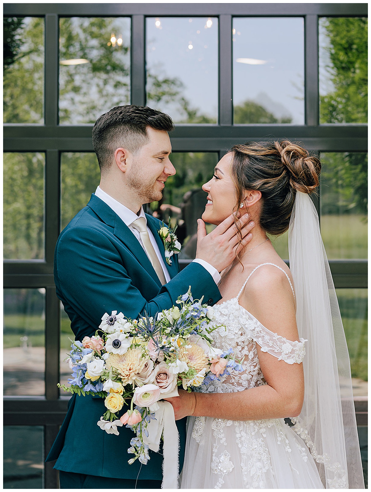 Groom holds brides face close for Kayla Bouren Photography