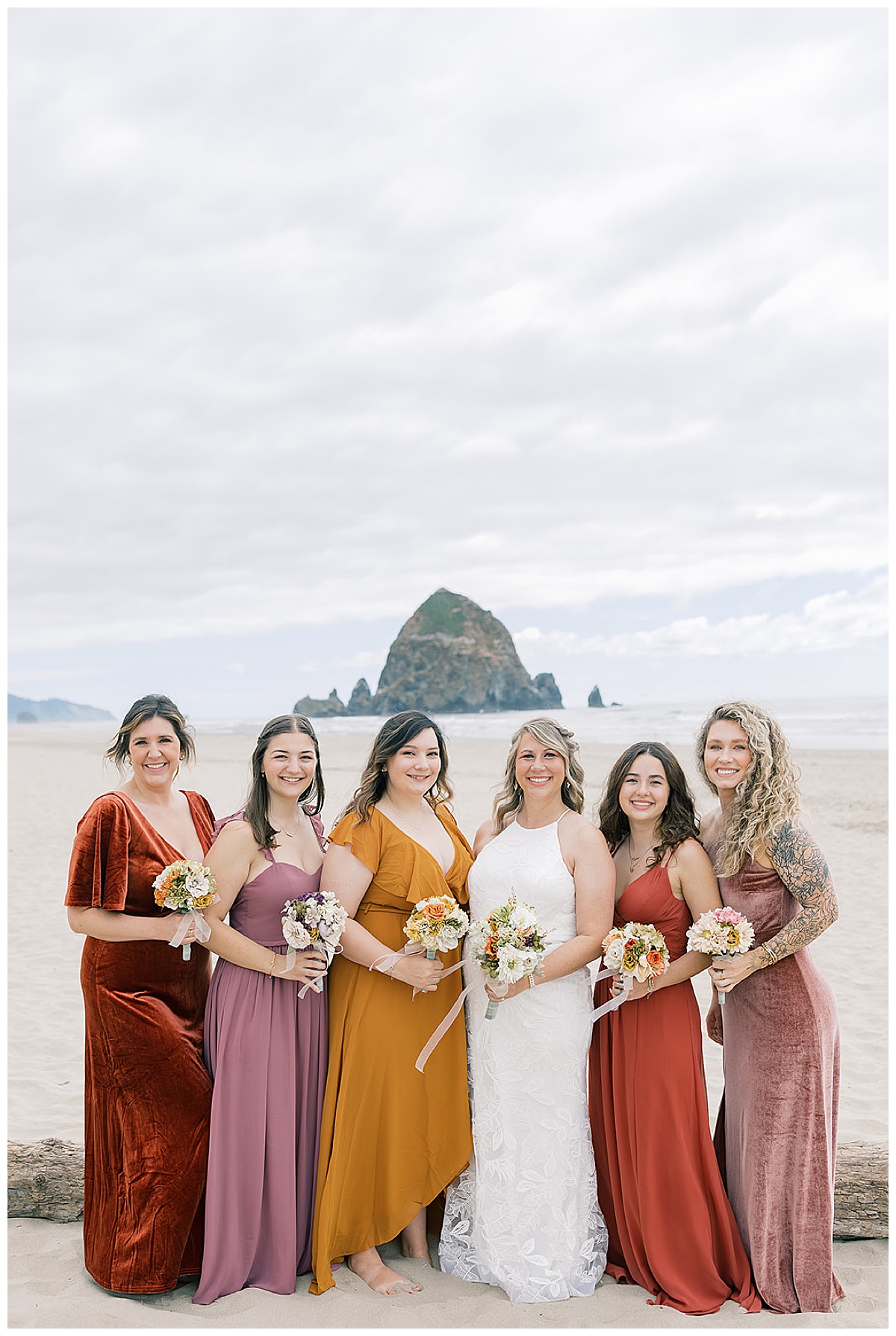 Gorgeous bridesmaids stand near bride for Cannon Beach, Oregon, wedding