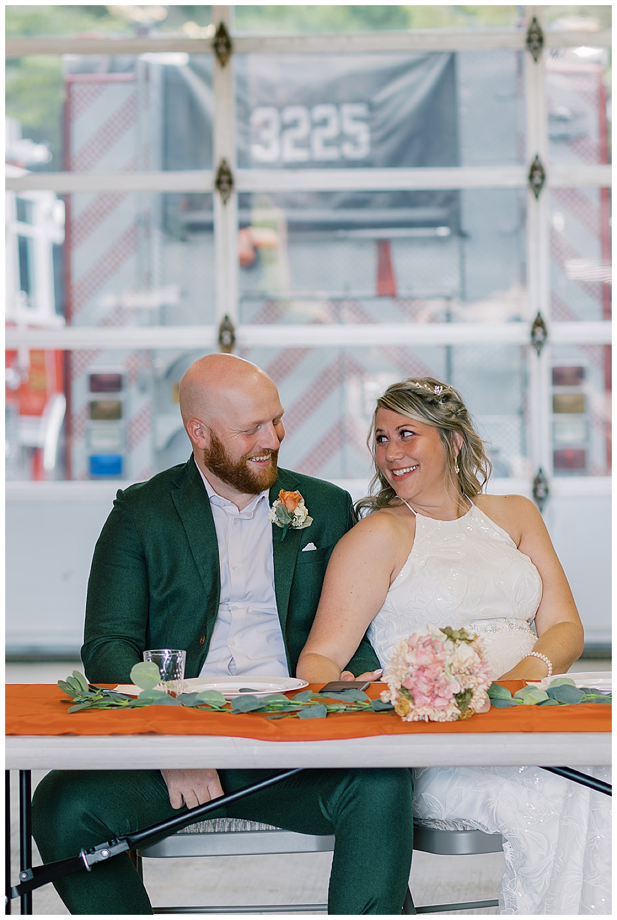 Husband and wife sit together and smile at one another for Detroit Wedding Photographer