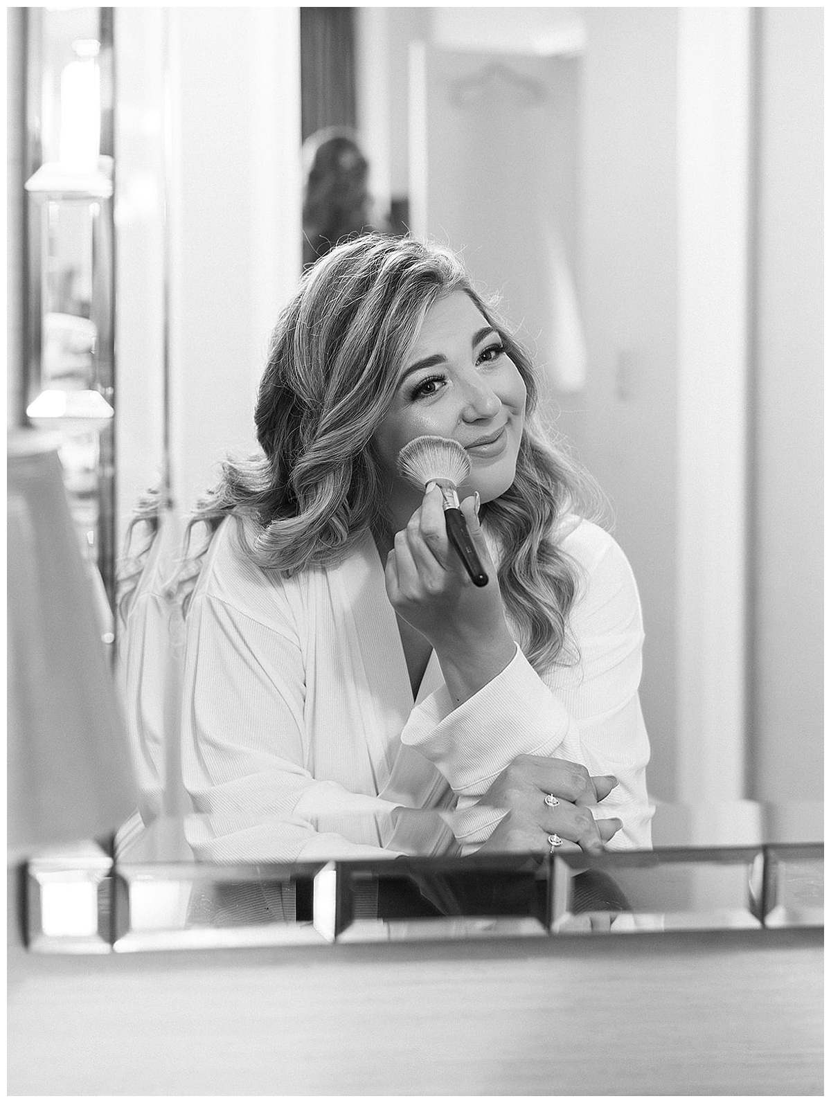 Bride applies makeup for Kayla Bouren Photography