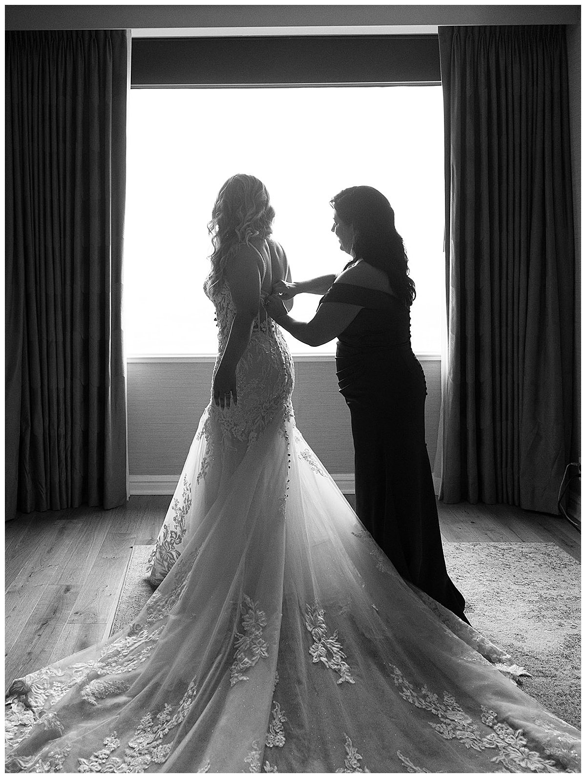 Woman helps bride into her gown fo Kayla Bouren Photography