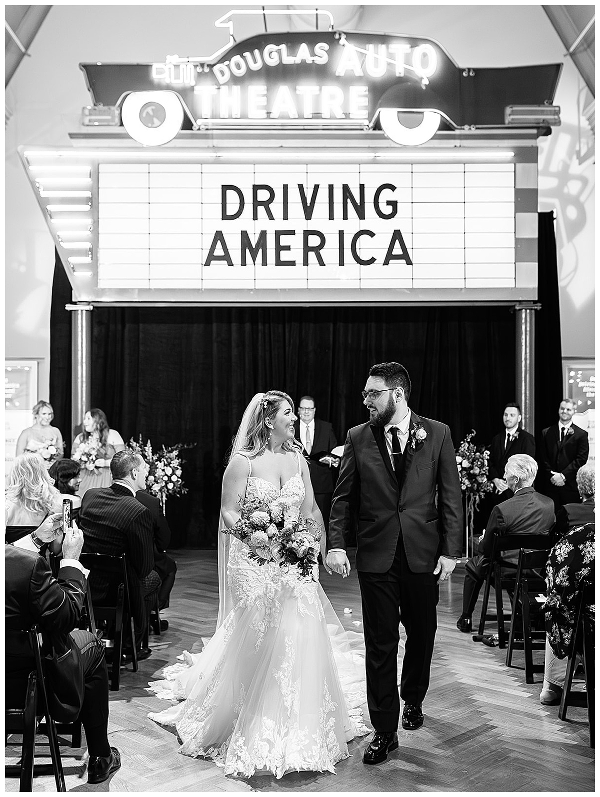Bride and groom walk hand and hand and smile at one another for Detroit Wedding Photographer