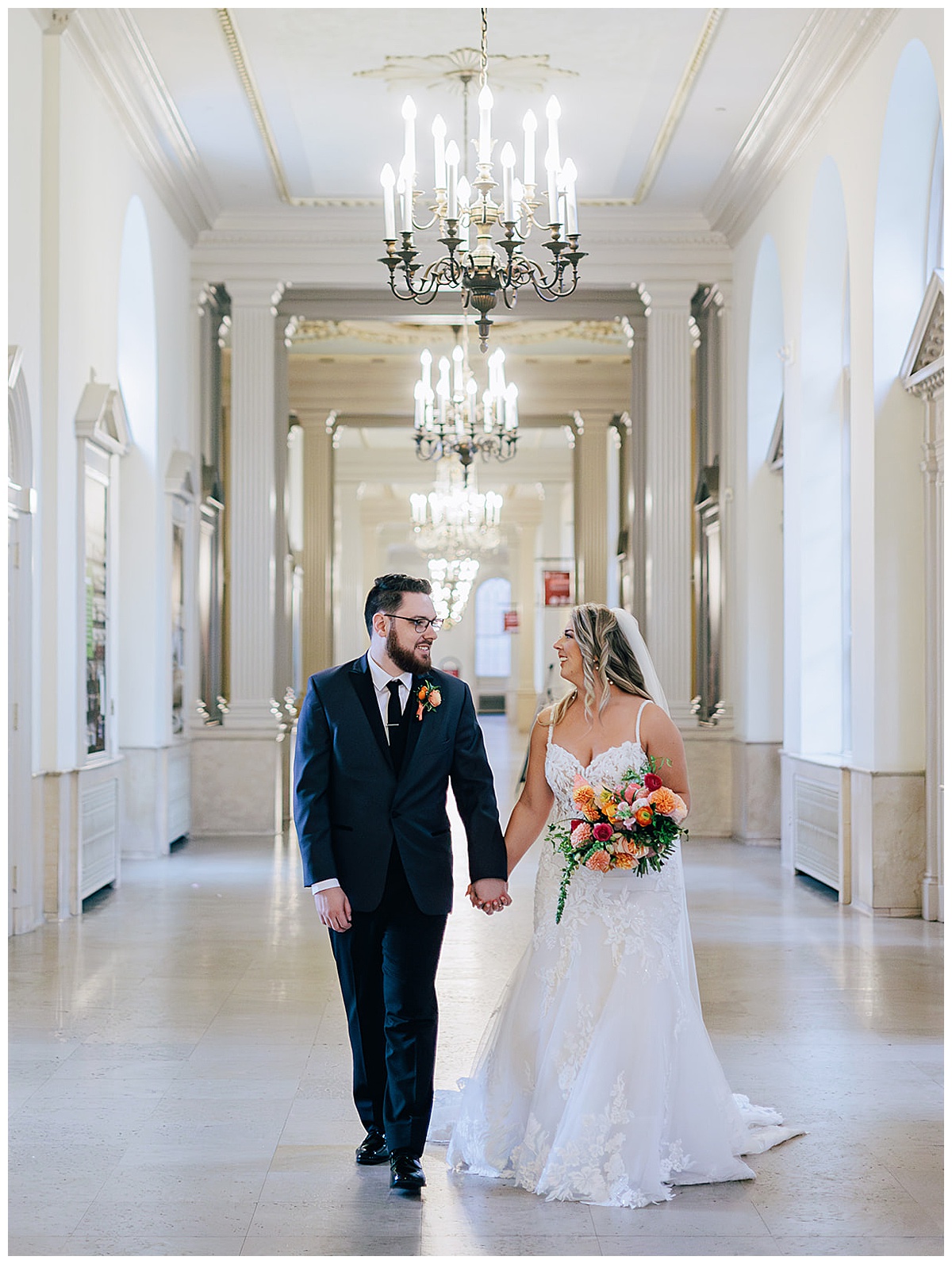 Bride and groom hold hands with big smiles for Kayla Bouren Photography