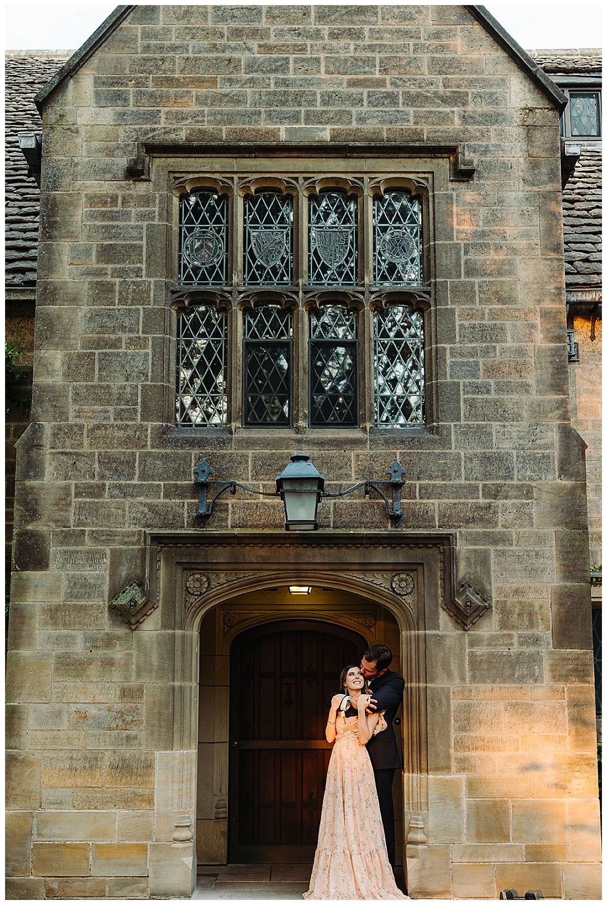 Couple stand under the luxurious estate for Kayla Bouren Photography