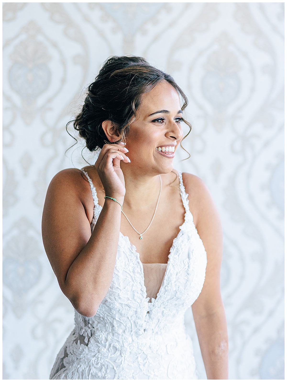 Woman adjusts earrings before wedding for Detroit Wedding Photographer