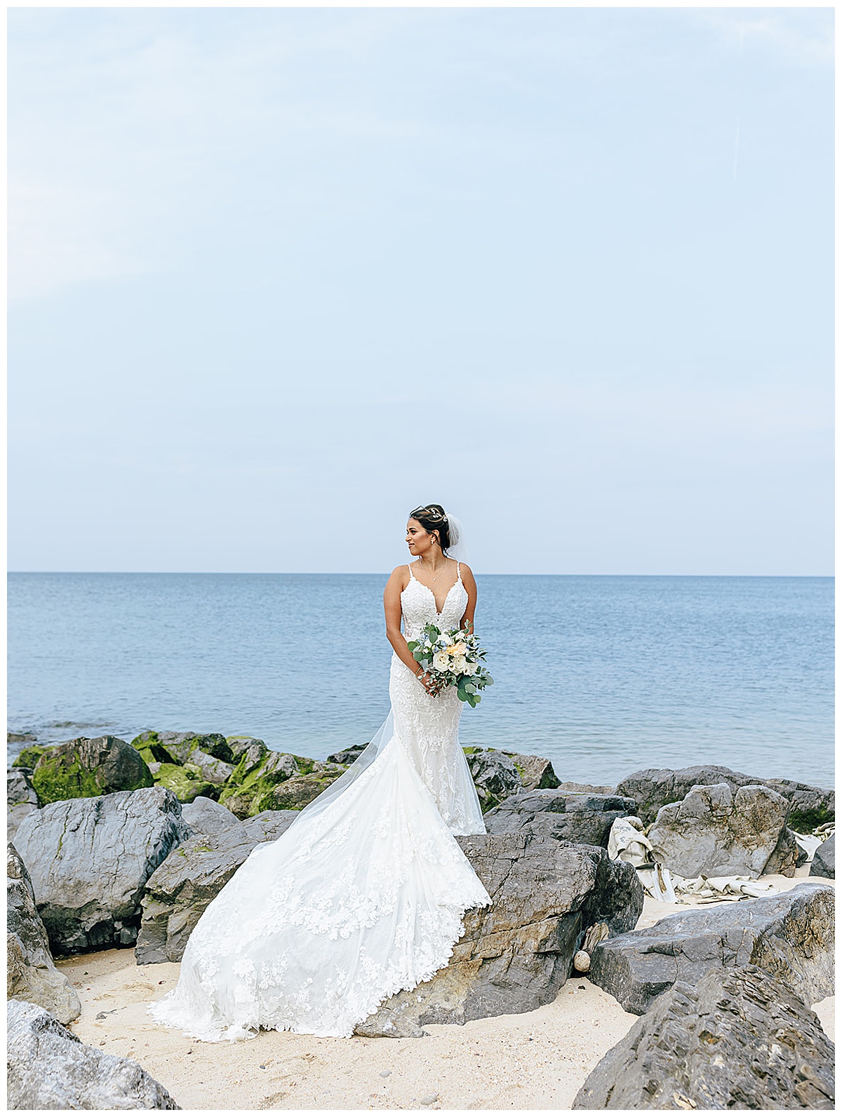 Bride stands on a rock at Giorgio's Baiting Hollow