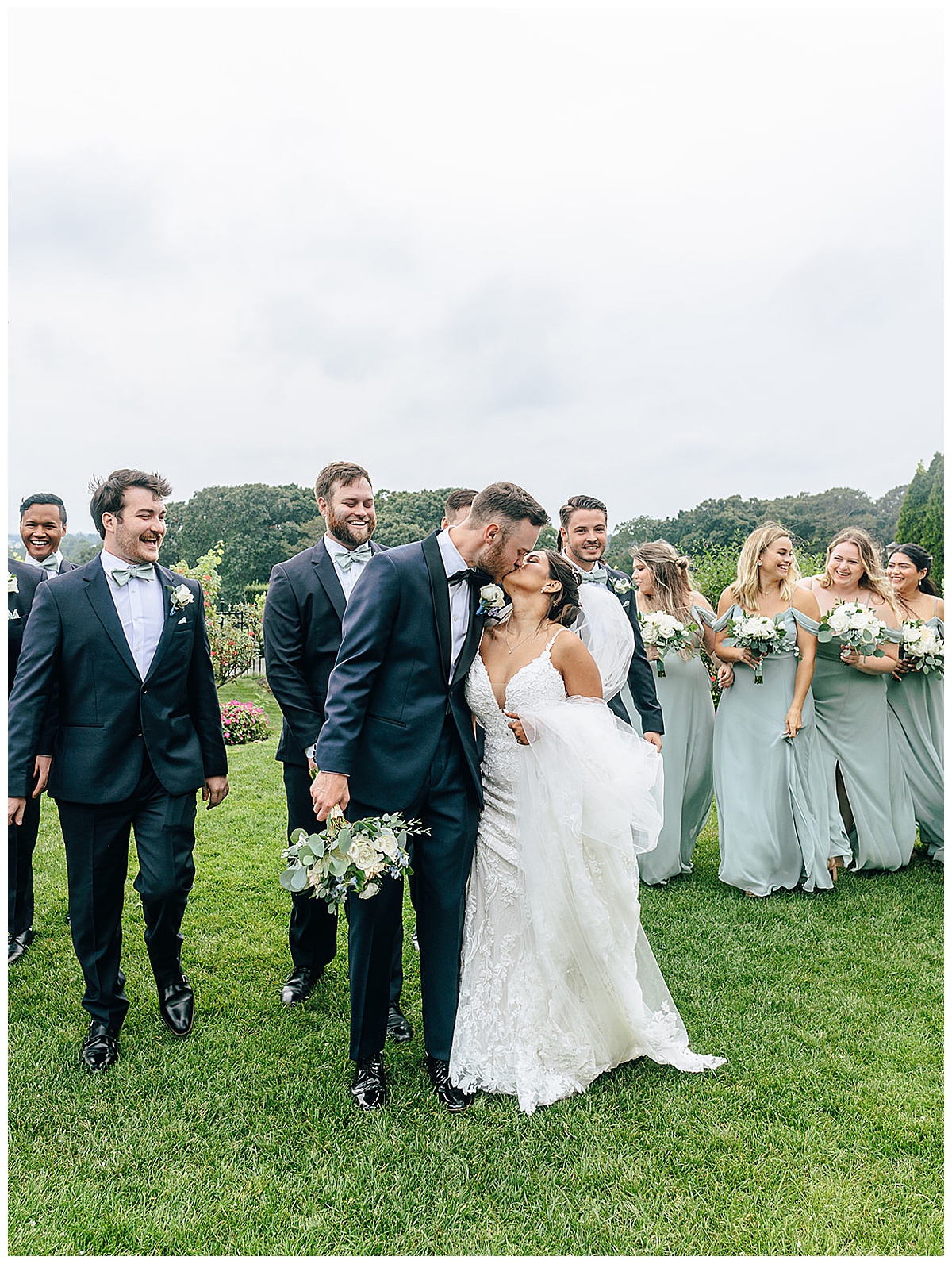 Couple walk together in front of family and friends for Detroit Wedding Photographer