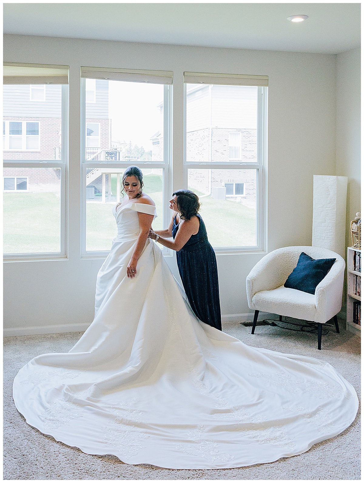 Bride is helped into her dress for her Luxury Wedding at Roostertail