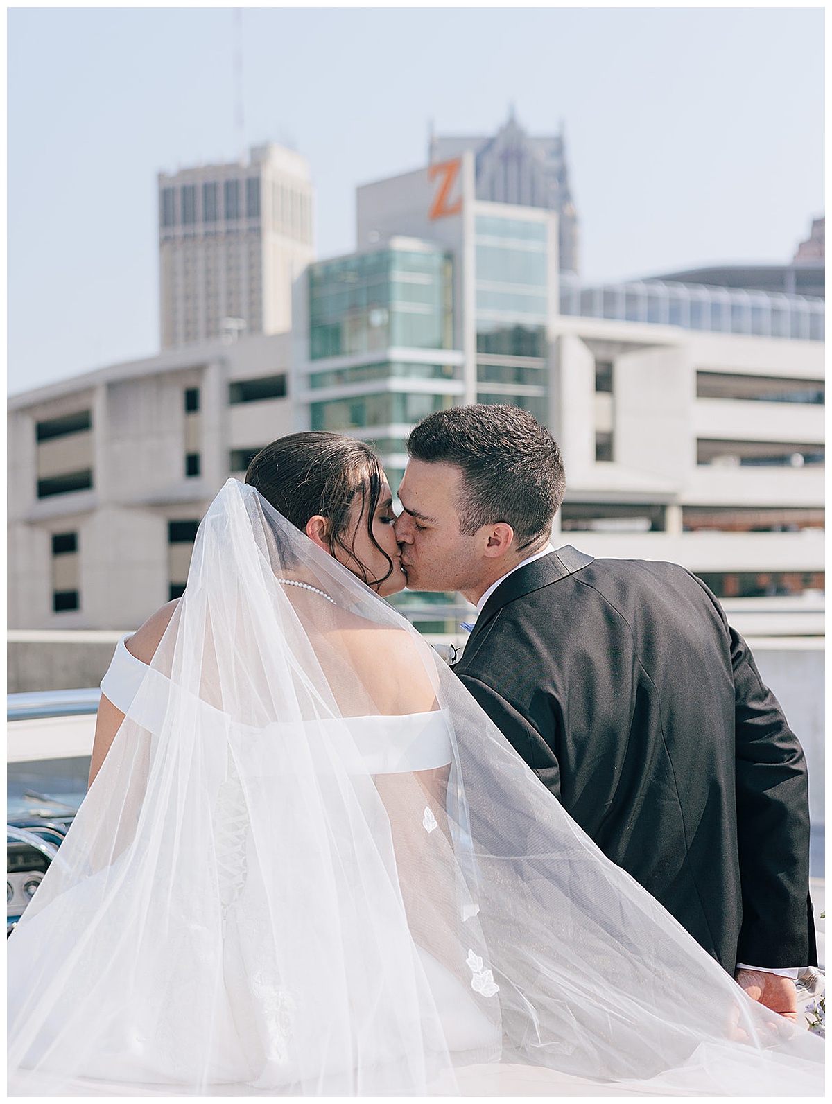 Bride and groom share a kiss for Kayla Bouren Photography