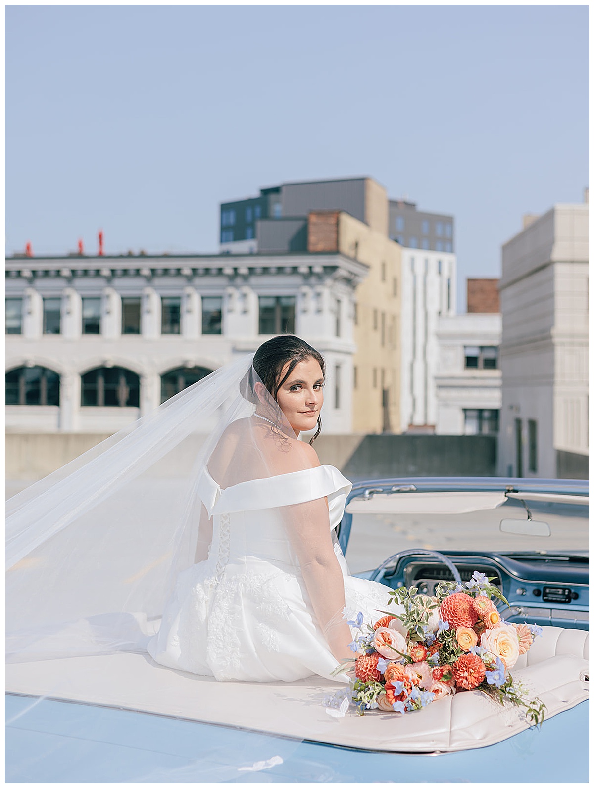 Bride sits on a vintage car for Kayla Bouren Photography