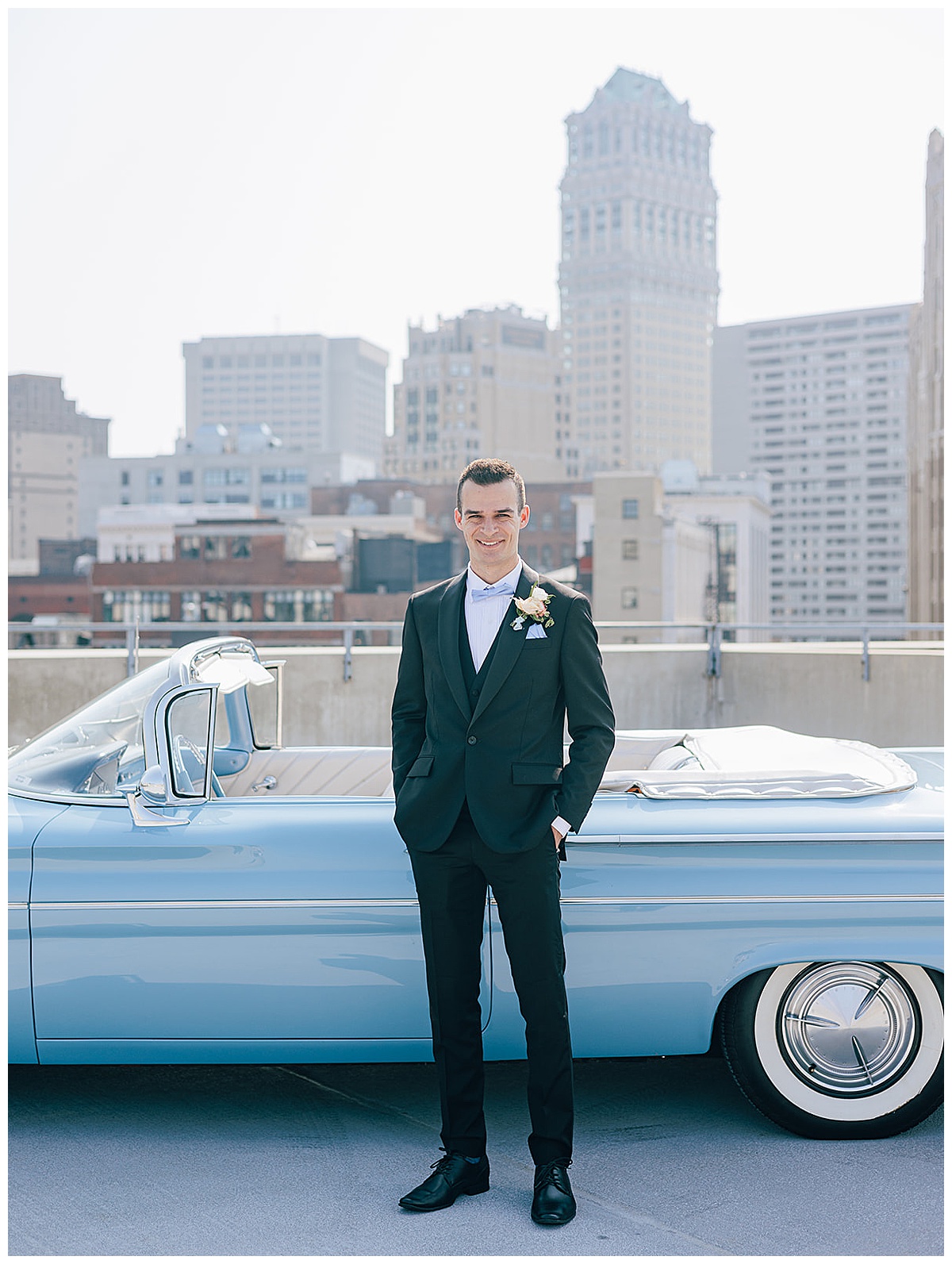 Groom stands in front of vintage car for Luxury Wedding at Roostertail