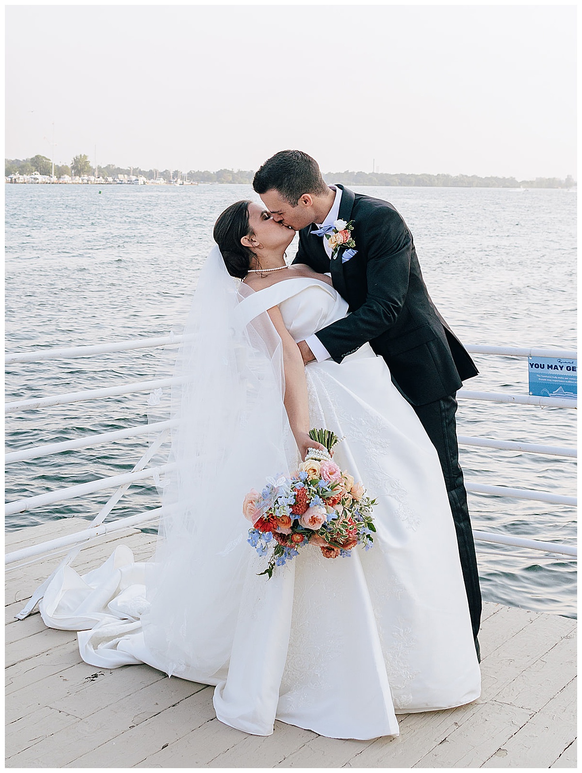 Husband and wife share a kiss for Luxury Wedding at Roostertail