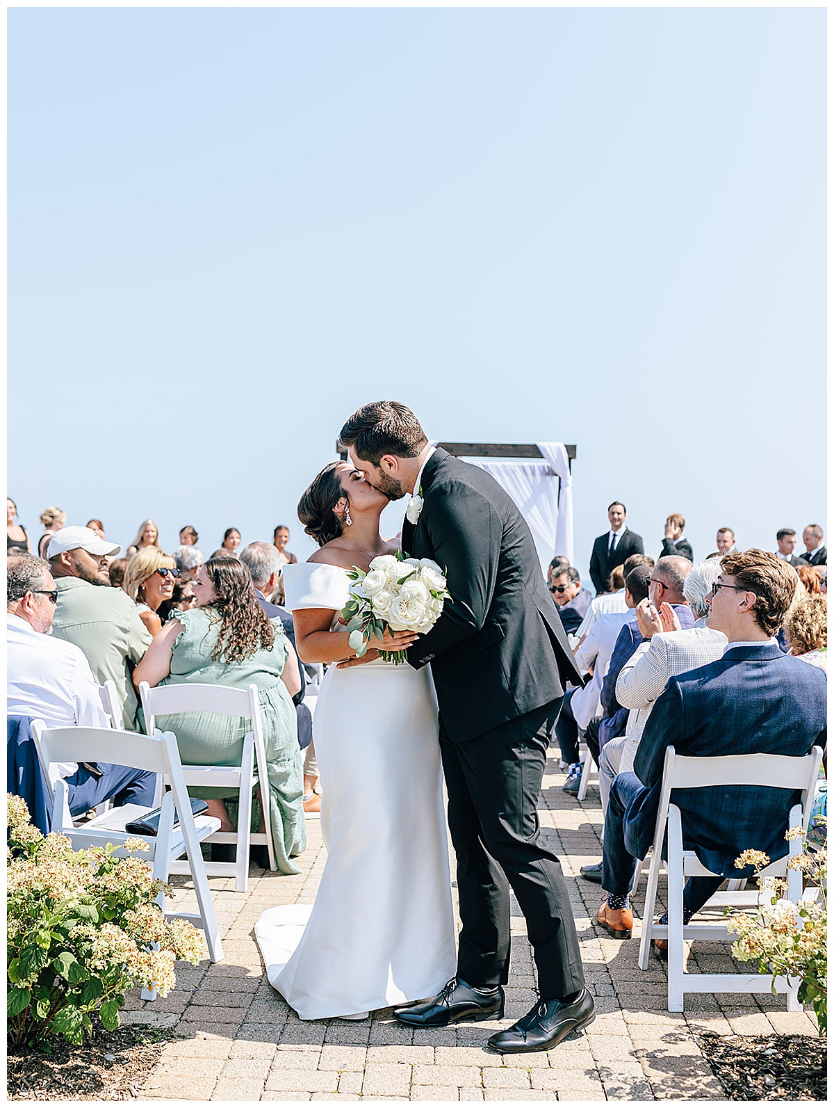 Bride and groom share a kiss for Kayla Bouren Photography