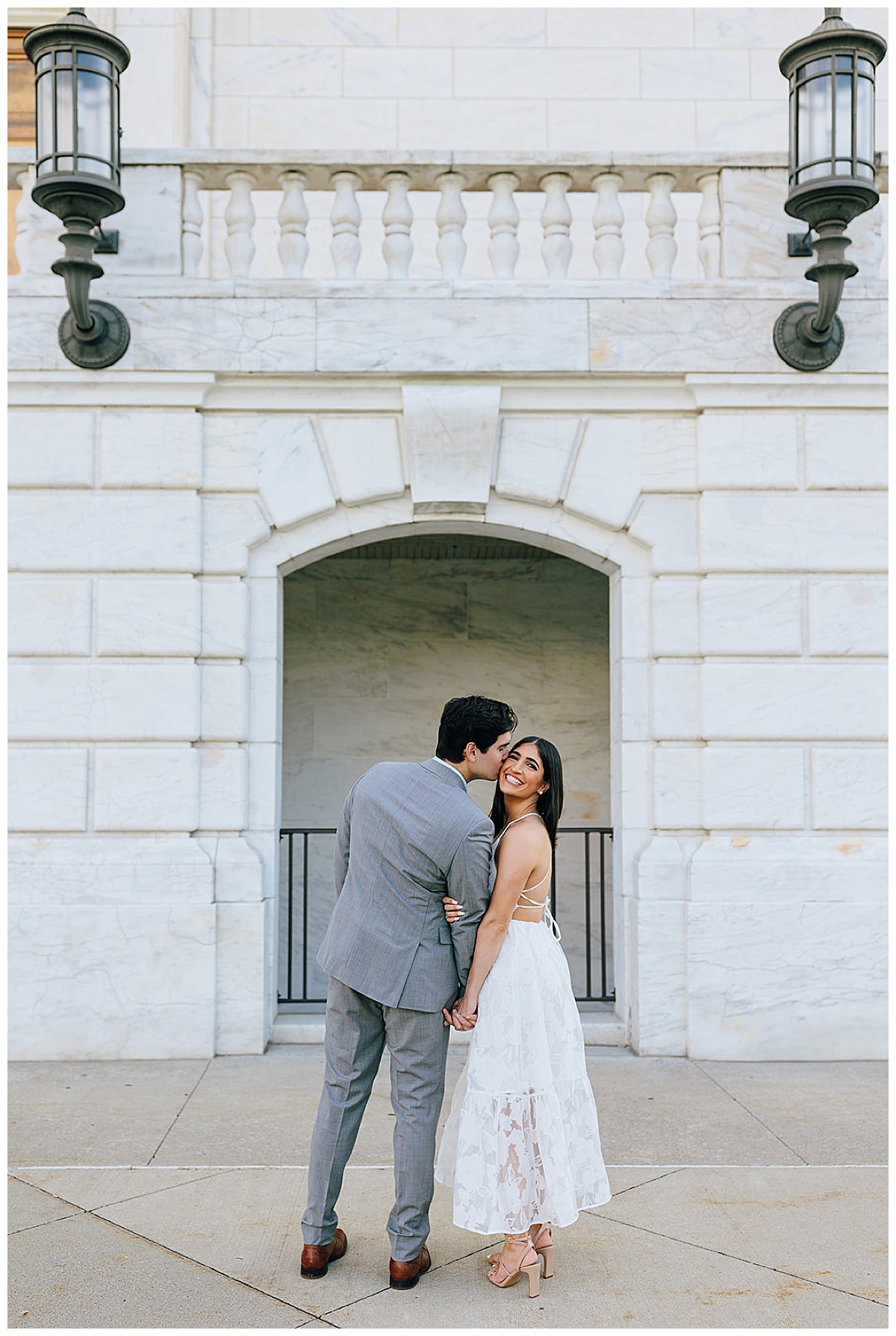A man kisses the woman on the cheek at one of the Iconic Detroit Locations for Your Engagement Session