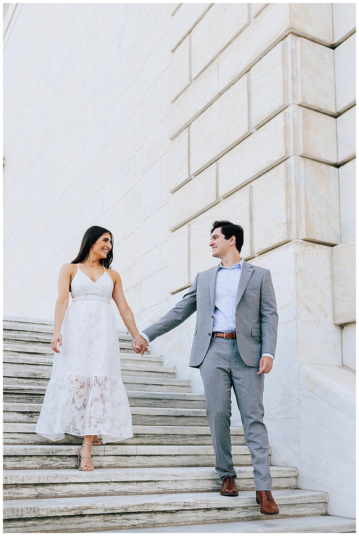 Couple walk hand in hand together down steps for Detroit Wedding Photographer