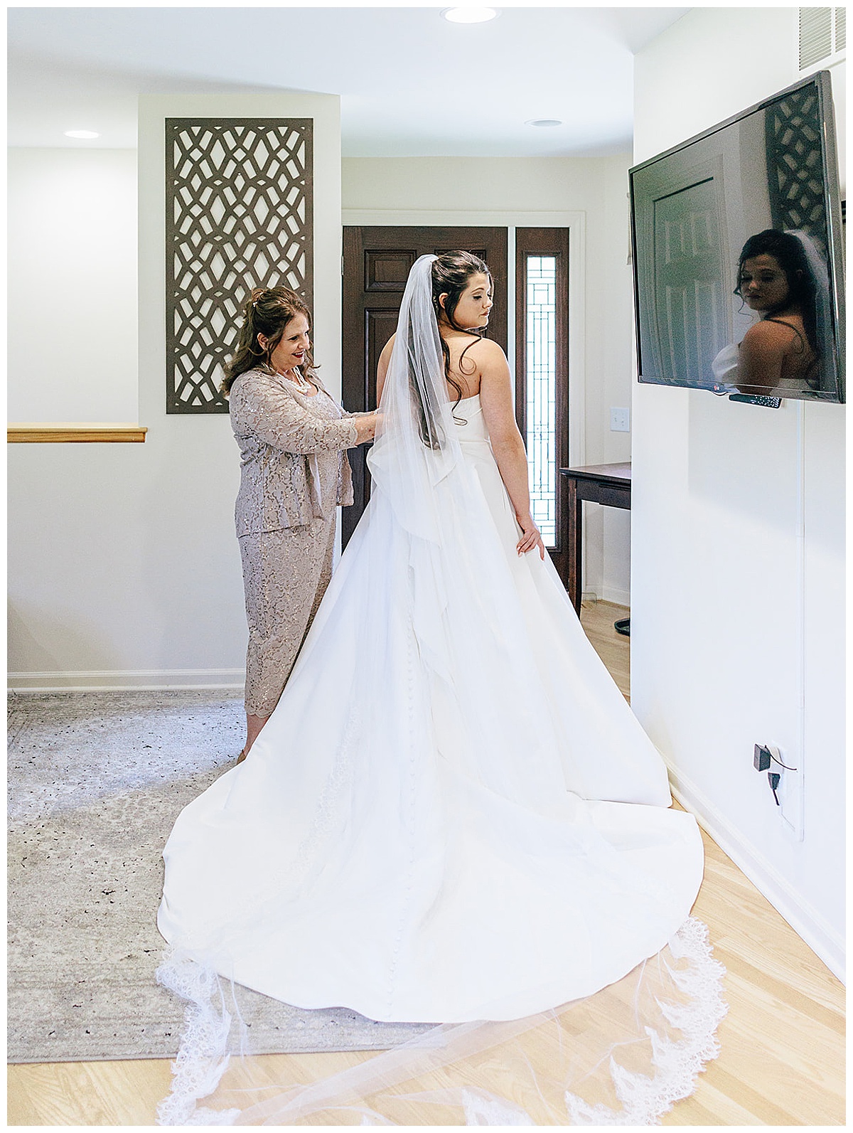 Bride puts on bridal gown for Detroit Wedding Photographer