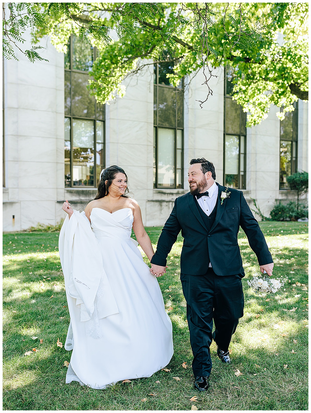 Bride and groom walk together for intimate backyard wedding