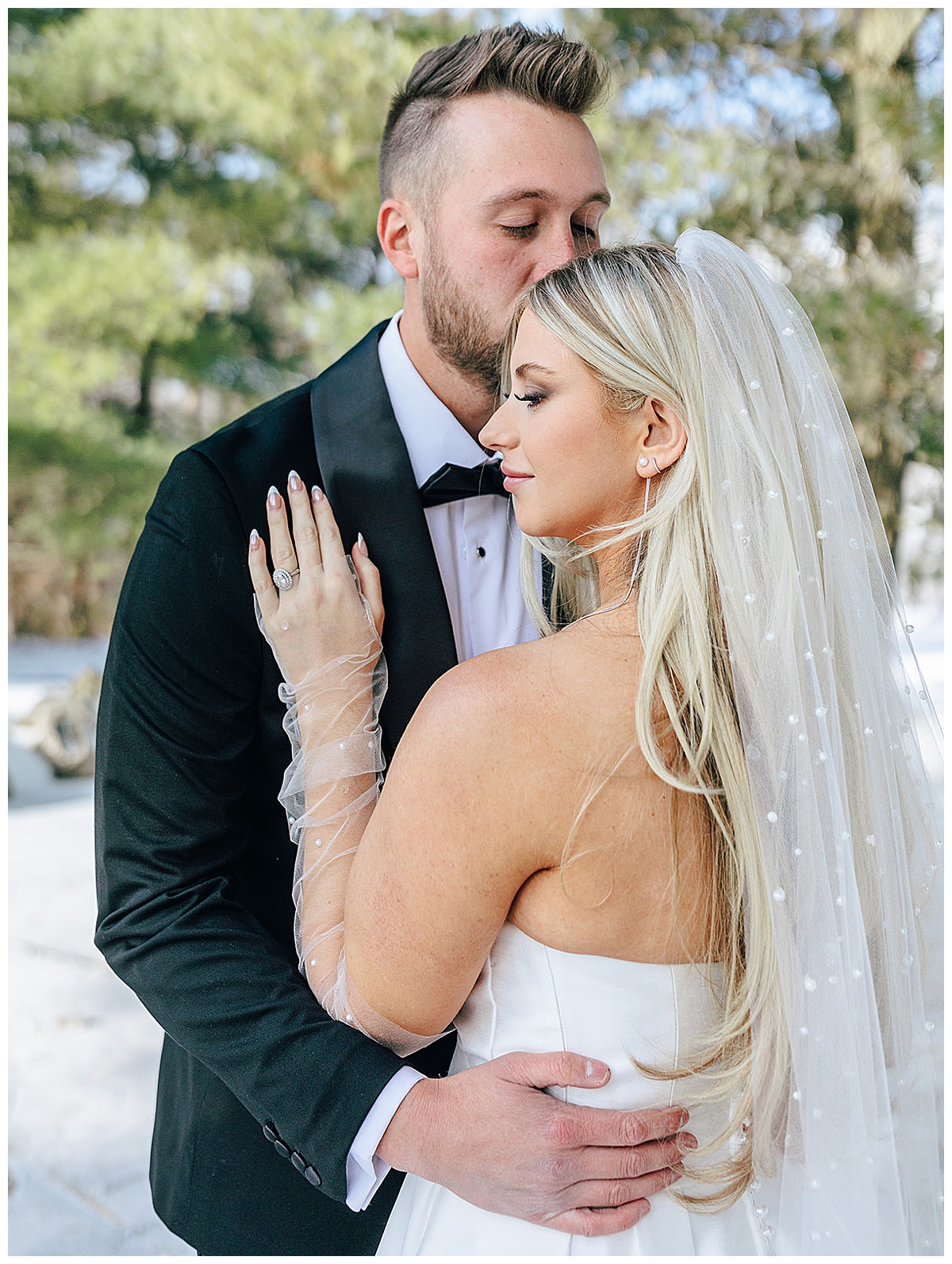 Bride holds hand on husbands chest for Kayla Bouren Photography