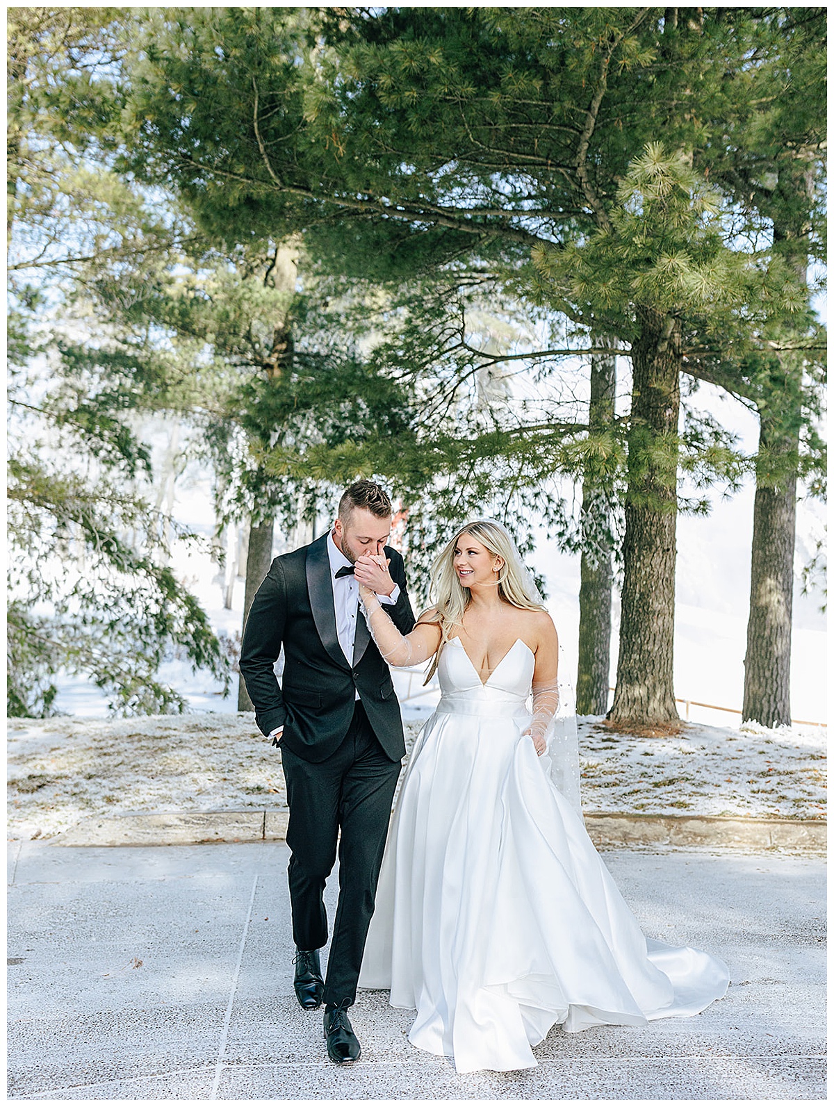 Couple walk together hand in hand for Snowy Winter Wonderland Wedding