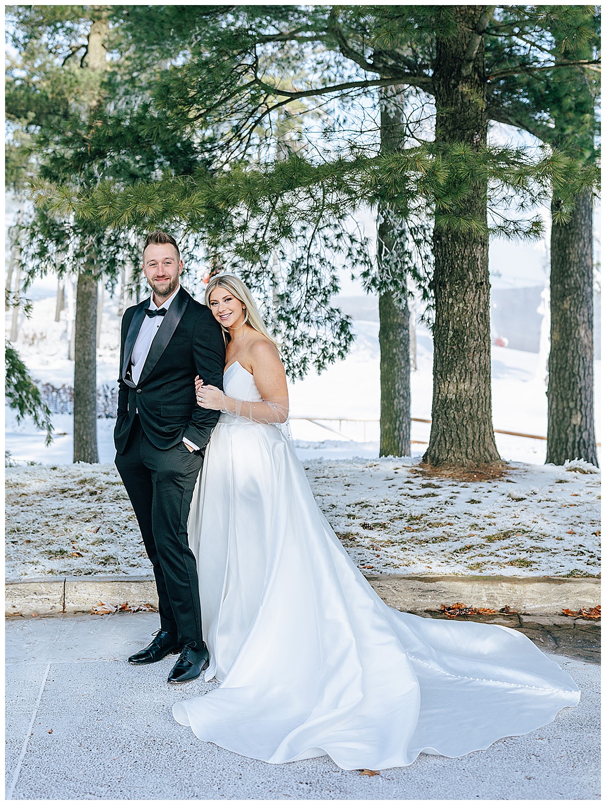 couple cuddle in close together for Snowy Winter Wonderland WeddingC