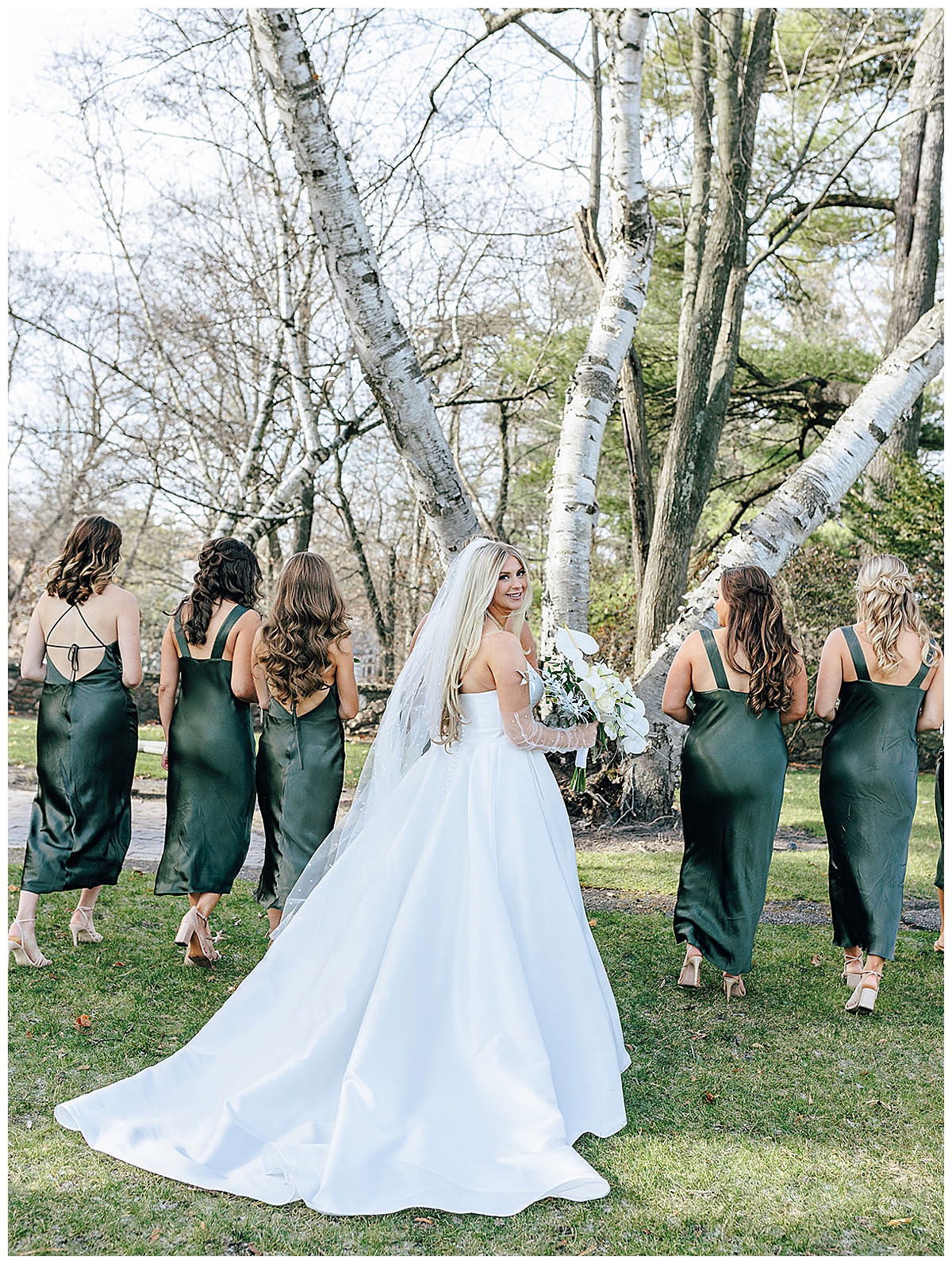 Bride walks with bridal party for Kayla Bouren Photography