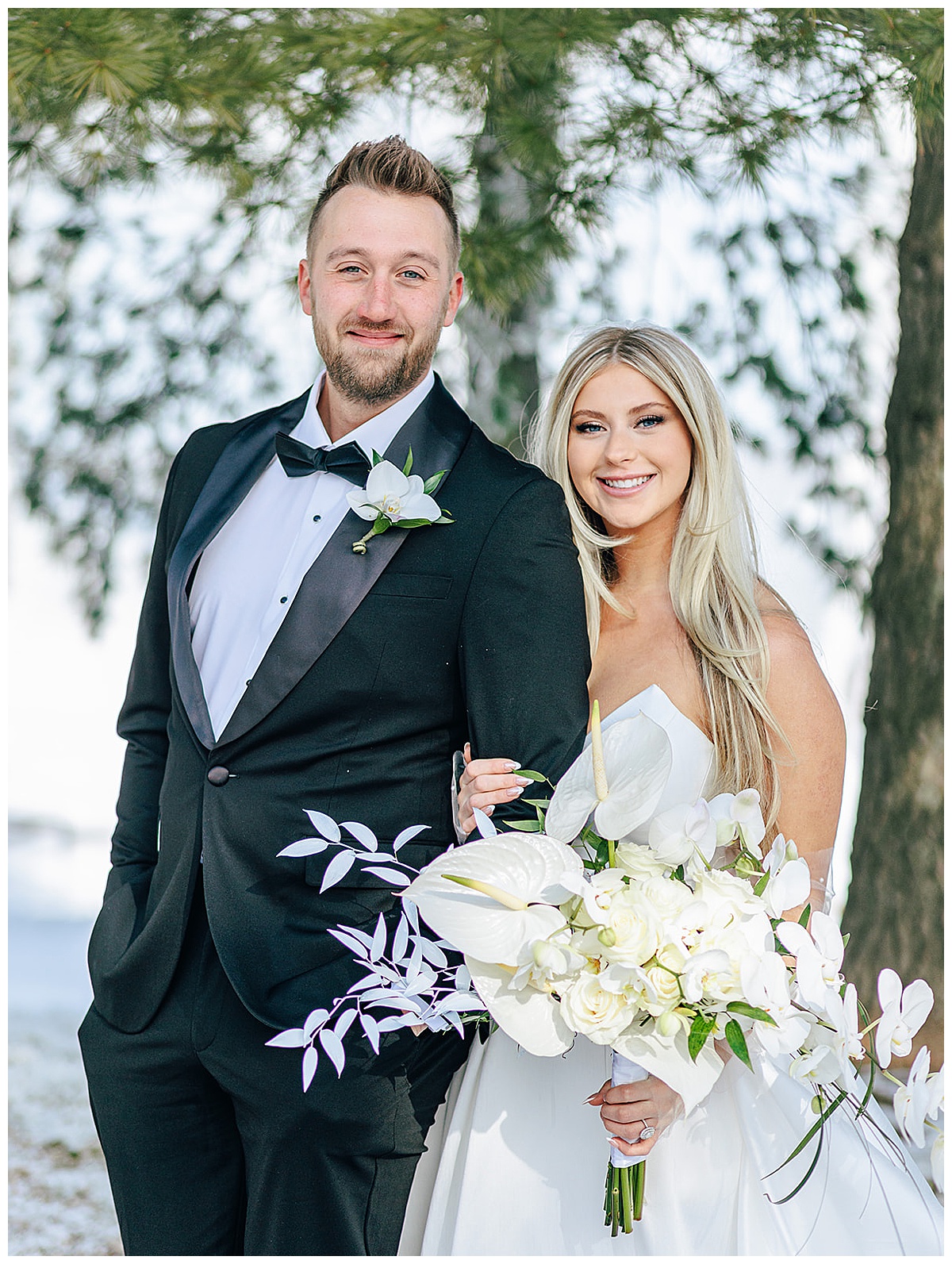 Couple hold each other and smile for Snowy Winter Wonderland Wedding