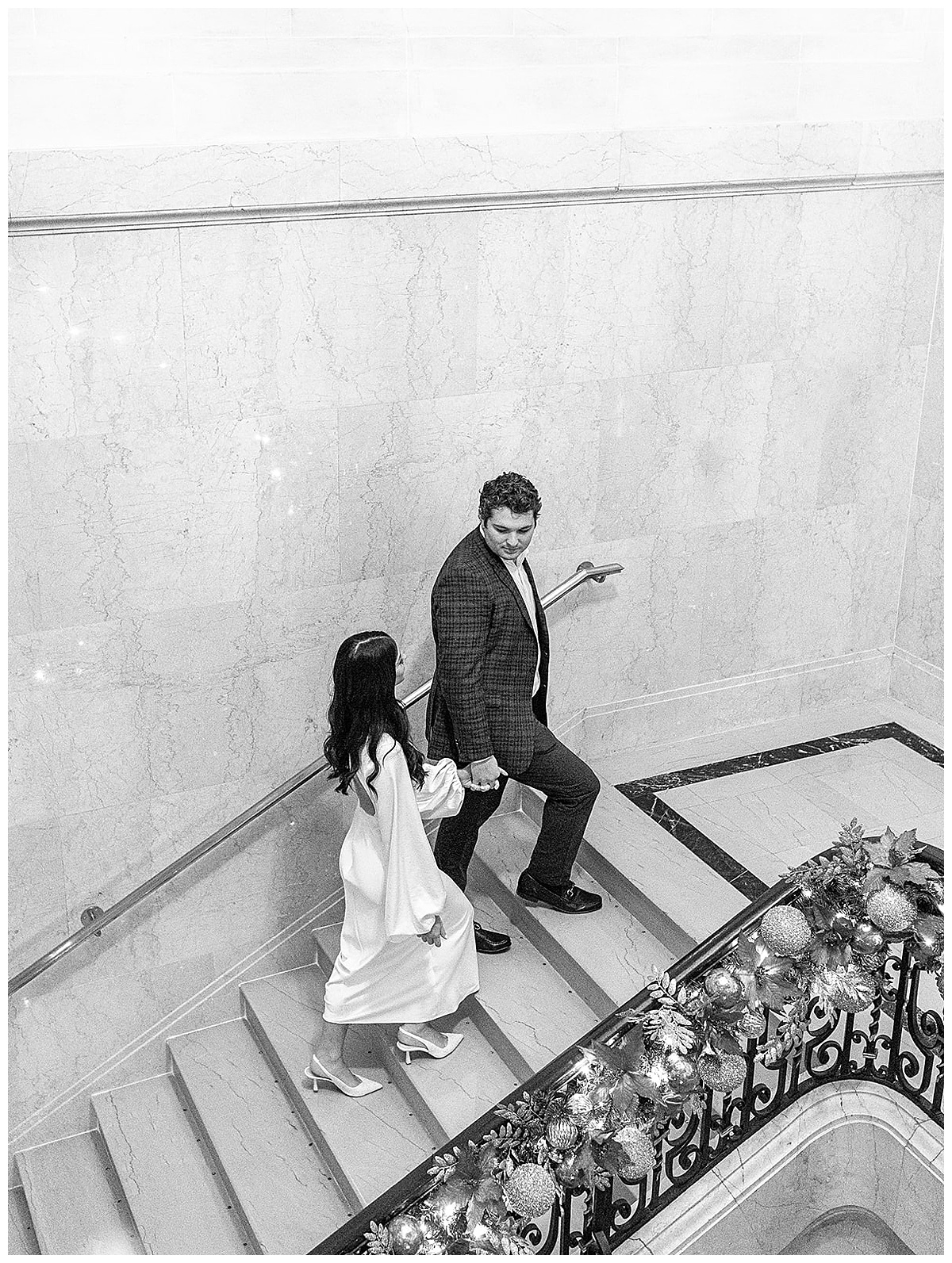 Man leads woman up the stairs for Kayla Bouren Photography
